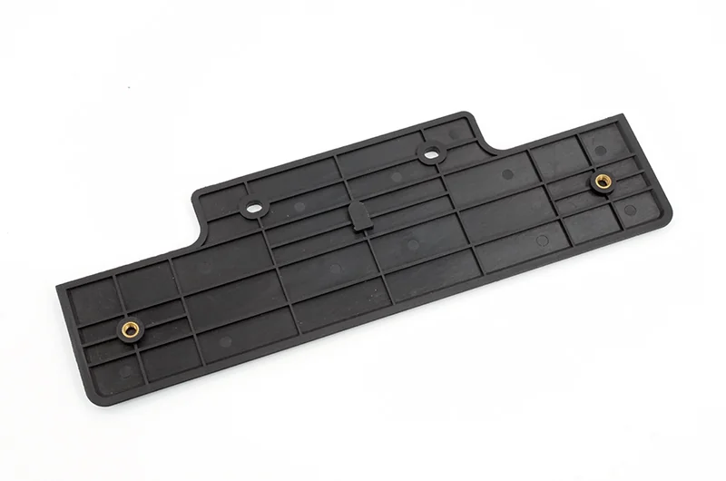 Black molded panel with reinforcing ribs and metal inserts